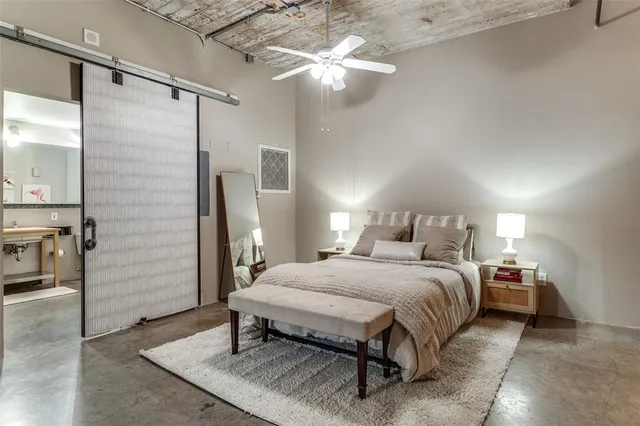 a bedroom with a bed window and a ceiling fan