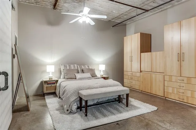 a bedroom with a bed and chandelier