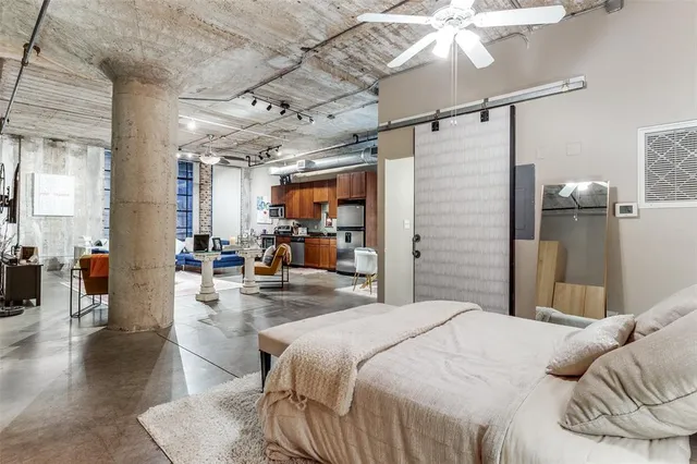 a bedroom with a bed and glass walk in closet