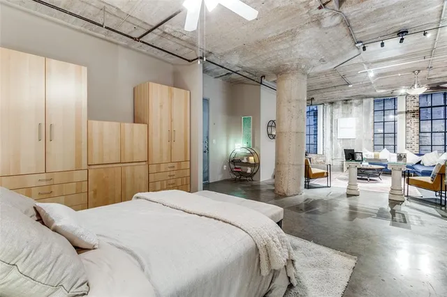 a bedroom with a bed a couch and furniture