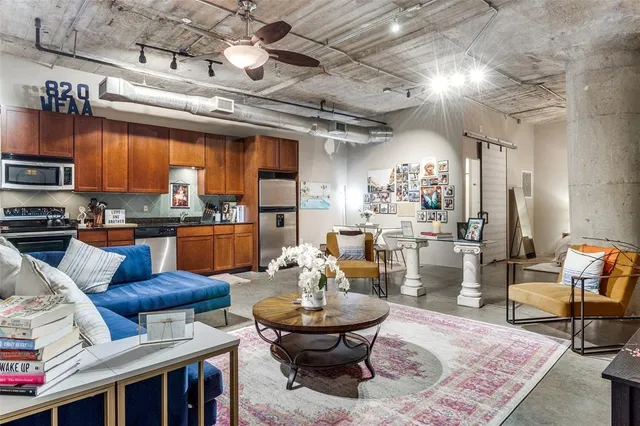 a living room with lots of furniture and kitchen view