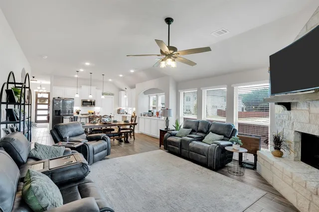 a living room with fireplace furniture and a flat screen tv