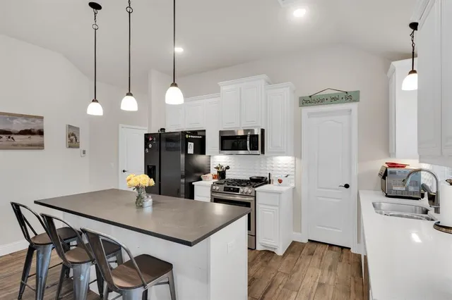 a kitchen with a dining table and chairs