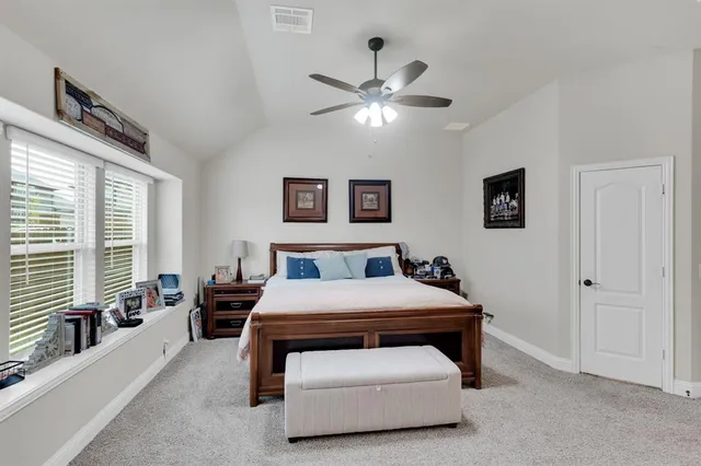 a bedroom with a bed and a large window