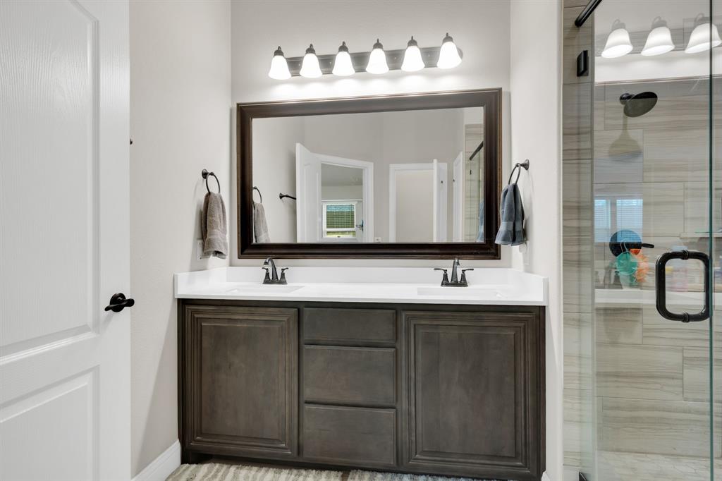5038 Ridgehurst Lane Midlothian, TX 76065 - Photo 18 of 37 a bathroom with a sink and a mirror