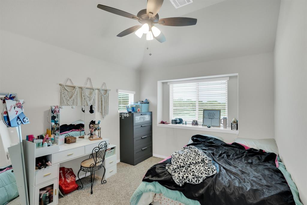 5038 Ridgehurst Lane Midlothian, TX 76065 - Photo 20 of 37 a bedroom with a bed and a chandelier