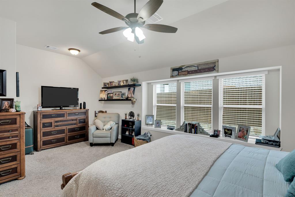 5038 Ridgehurst Lane Midlothian, TX 76065 - Photo 21 of 37 a bedroom with furniture and a flat screen tv