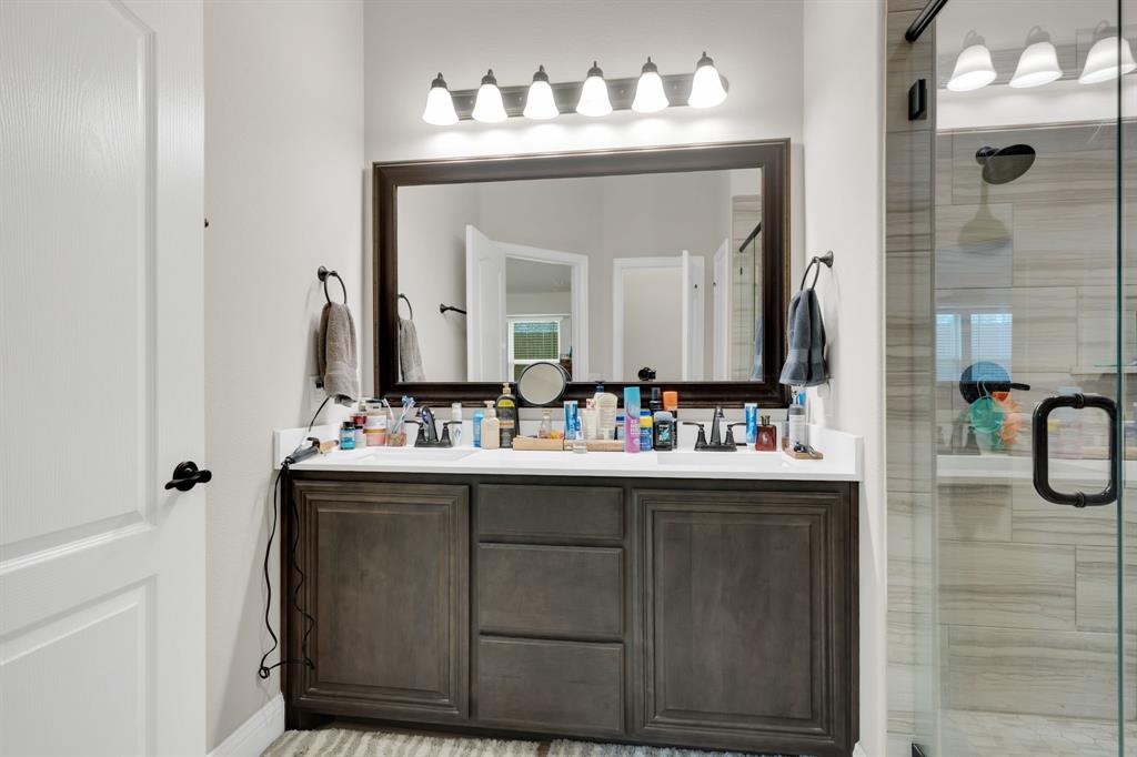 5038 Ridgehurst Lane Midlothian, TX 76065 - Photo 22 of 37 a bathroom with a sink vanity and mirror