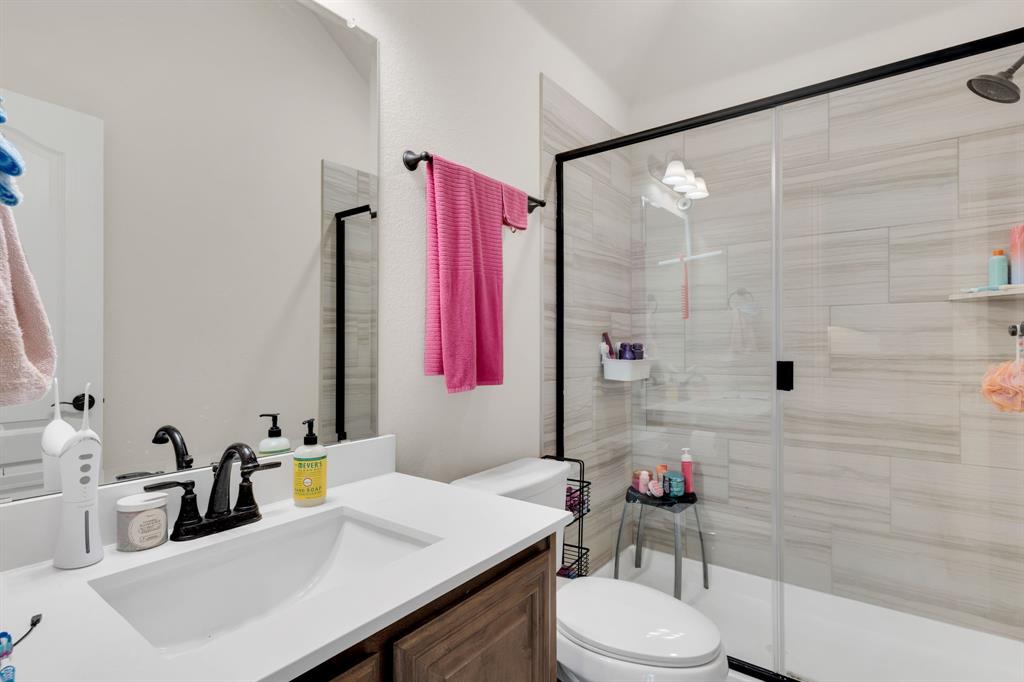 5038 Ridgehurst Lane Midlothian, TX 76065 - Photo 26 of 37 a bathroom with a sink vanity mirror and toilet