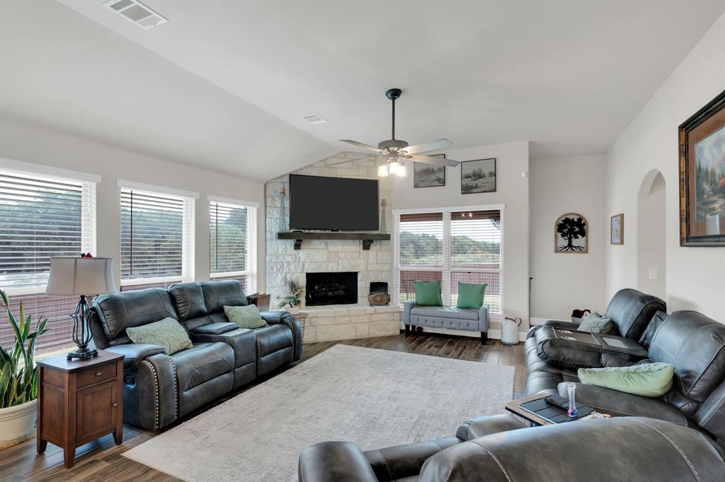 5038 Ridgehurst Lane Midlothian, TX 76065 - Photo 4 of 37 a living room with furniture flat screen tv and a fireplace