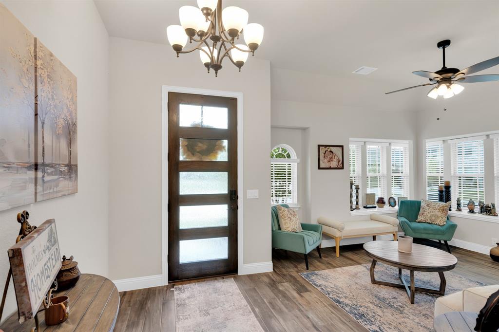 5038 Ridgehurst Lane Midlothian, TX 76065 - Photo 7 of 37 a living room with furniture a chandelier and a window