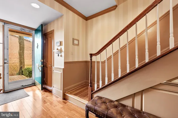 a view of an entryway with wooden floor and door