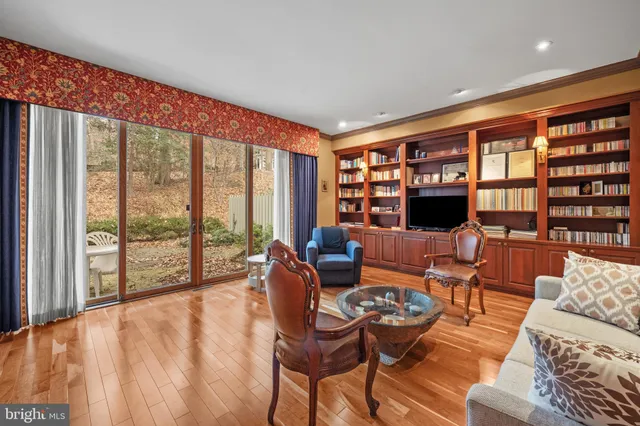 a living room with furniture floor to ceiling window and floor to ceiling window