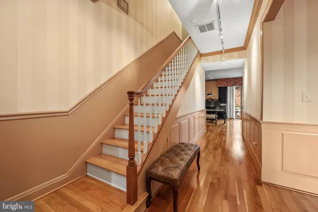 a view of entryway and hall with wooden floor