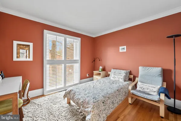 a bedroom with furniture and a window