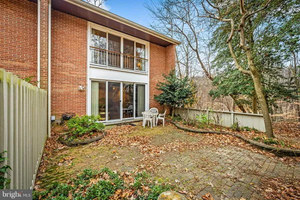 a view of house with backyard and glass windows