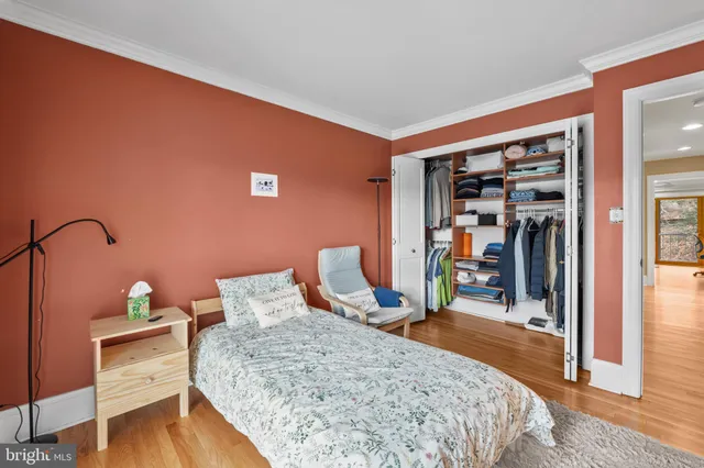 a bedroom with a bed and a desk