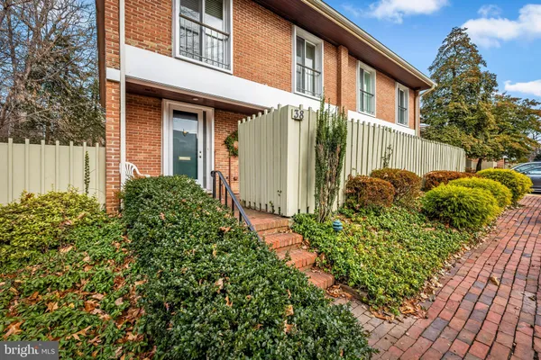 a view of a house with brick walls and a plants
