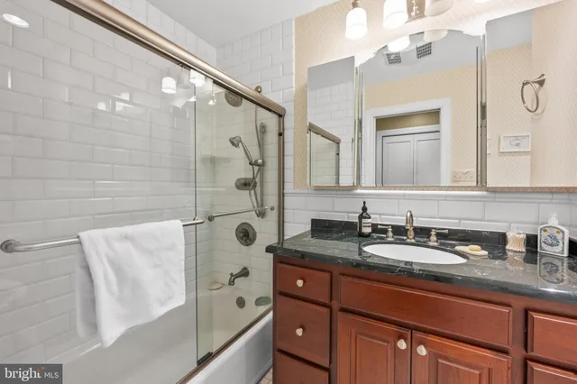 a bathroom with a tub sink and mirror