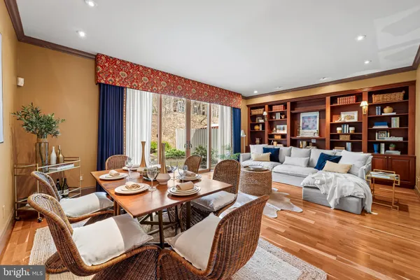 a living room with furniture and large windows