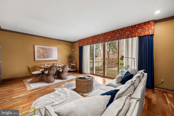 a living room with furniture and large windows