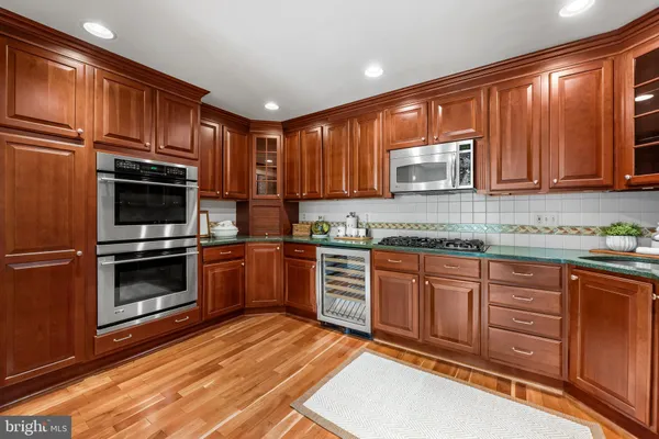 a kitchen with stainless steel appliances granite countertop a stove a sink dishwasher and a microwave oven with cabinets