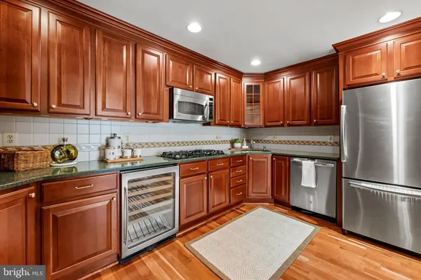 a kitchen with stainless steel appliances granite countertop a refrigerator sink and cabinets