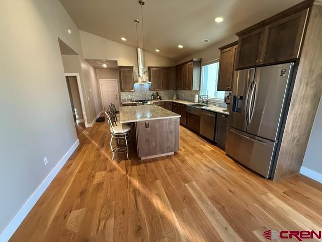 17823 6353 Road Montrose, CO 81403 - Photo 14 of 39 a kitchen with kitchen island wooden floors appliances and counter space
