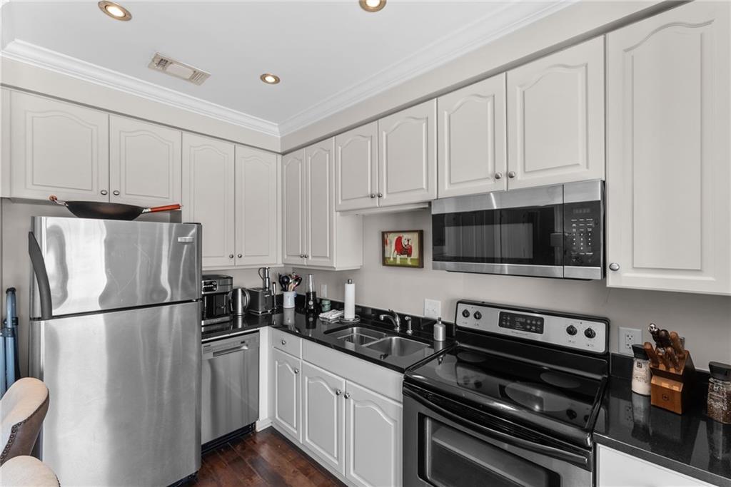 755 West Broad Street, Unit 820 Athens, GA 30601 - Photo 13 of 64 a kitchen with stainless steel appliances a refrigerator a stove a sink and cabinets