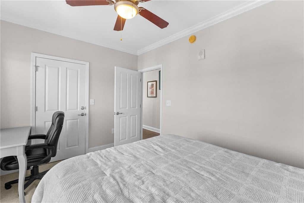 755 West Broad Street, Unit 820 Athens, GA 30601 - Photo 20 of 64 a bedroom with a bed and a chandelier