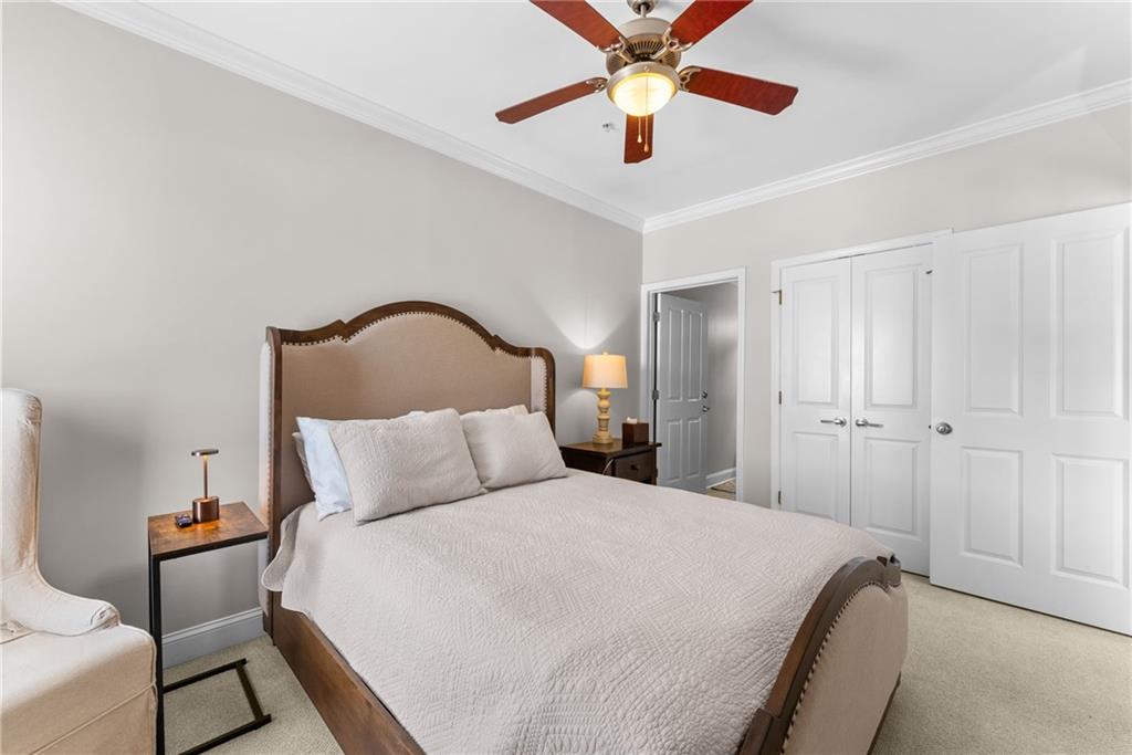 755 West Broad Street, Unit 820 Athens, GA 30601 - Photo 26 of 64 a bedroom with a bed and a ceiling fan
