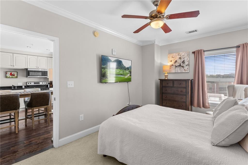 755 West Broad Street, Unit 820 Athens, GA 30601 - Photo 27 of 64 a bedroom with a bed and a chandelier