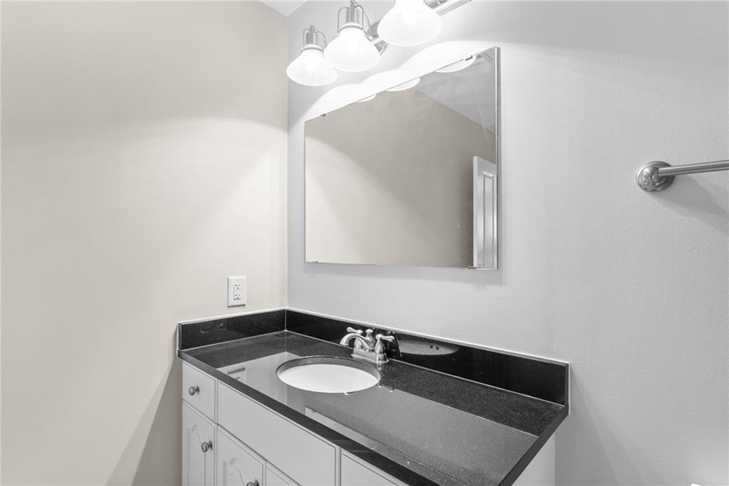 755 West Broad Street, Unit 820 Athens, GA 30601 - Photo 29 of 64 a bathroom with a sink vanity and a mirror