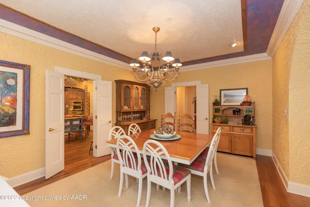 a view of a dining room with furniture and chandelier