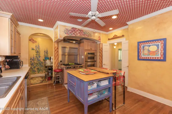 a living room with furniture a rug and a chandelier