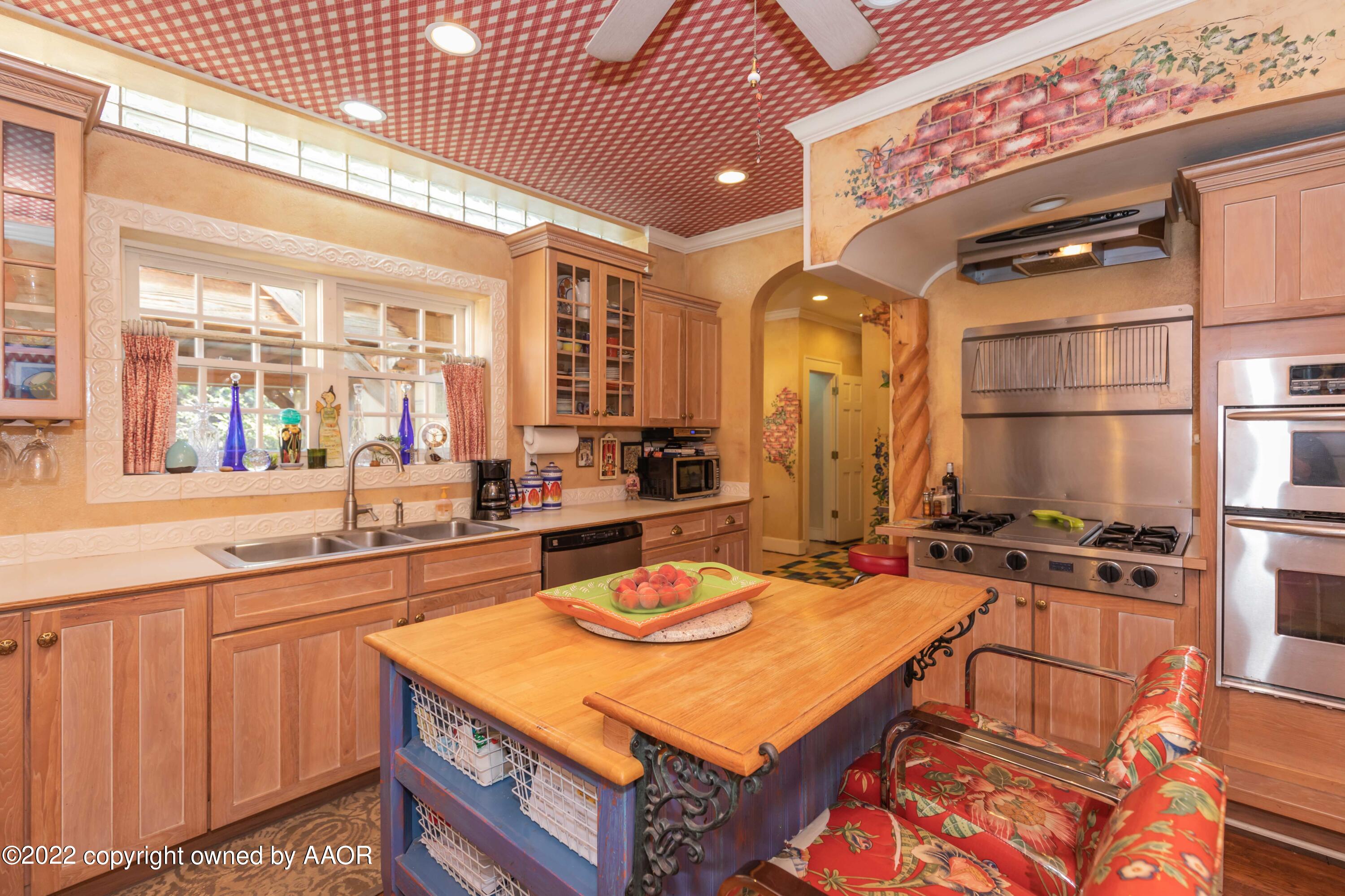 1607 South Harrison Street Amarillo, TX 79102 - Photo 19 of 71 a kitchen with a sink stove and cabinets