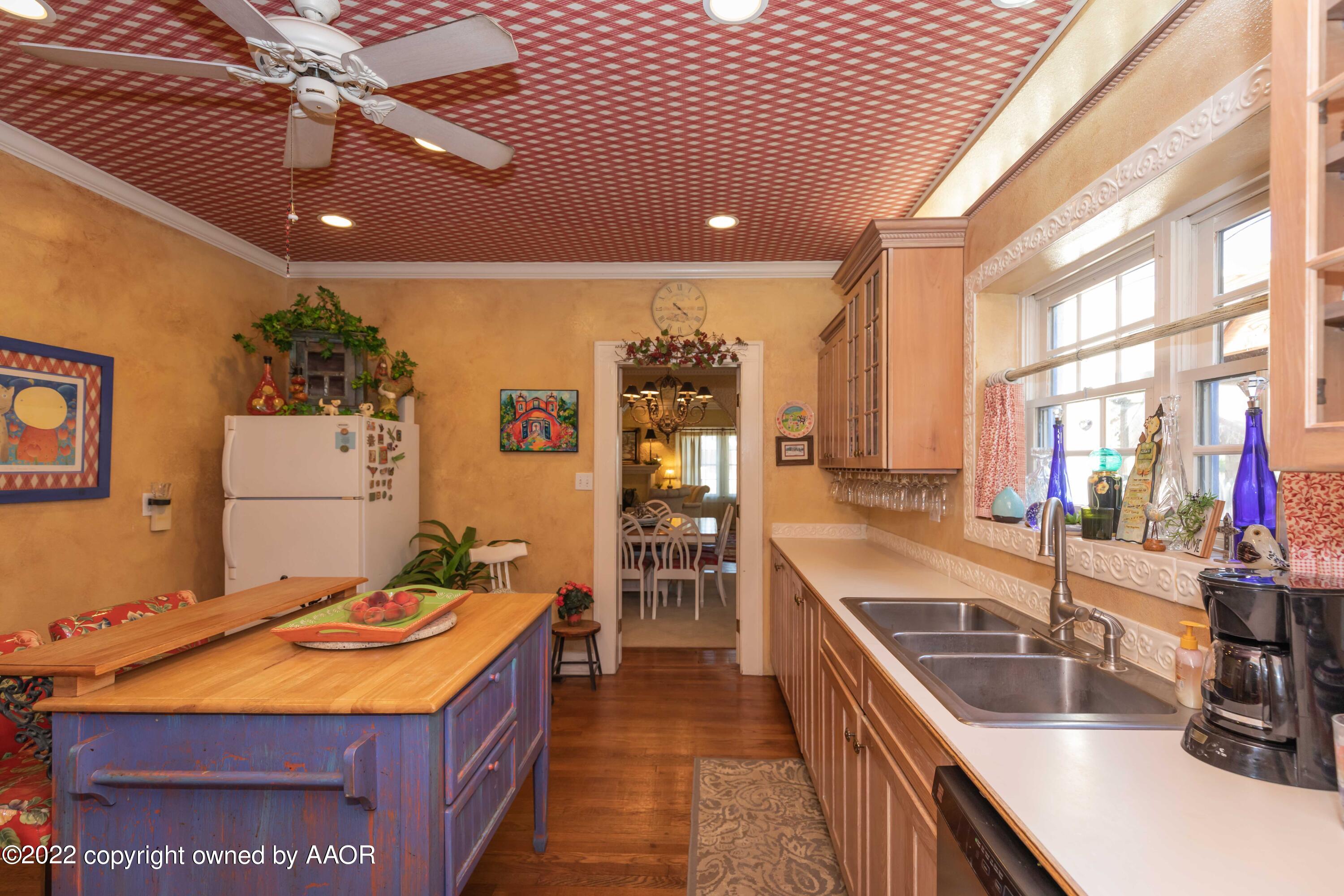1607 South Harrison Street Amarillo, TX 79102 - Photo 21 of 71 a kitchen with stainless steel appliances kitchen island granite countertop a sink and cabinets
