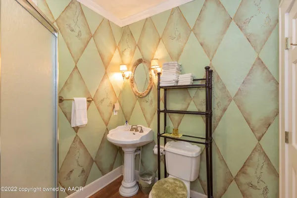 a bathroom with a toilet a sink and a shower curtain