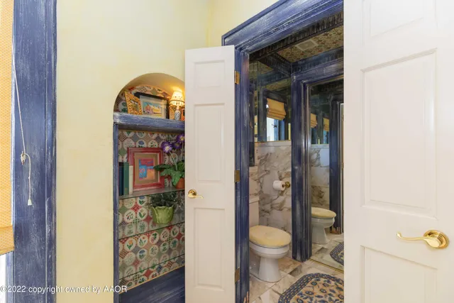 a bedroom with furniture and a rug