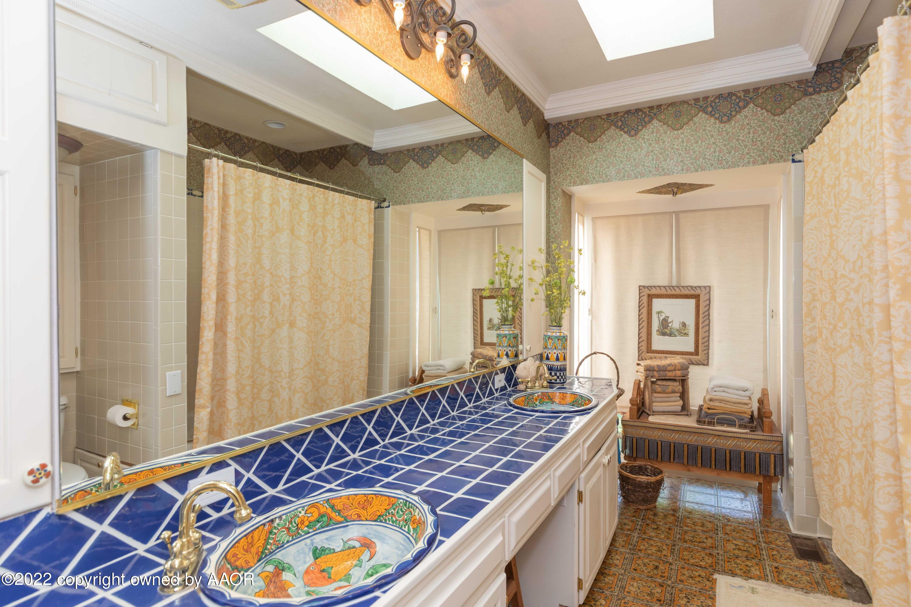 1607 South Harrison Street Amarillo, TX 79102 - Photo 42 of 71 a bedroom with a bed and a chandelier