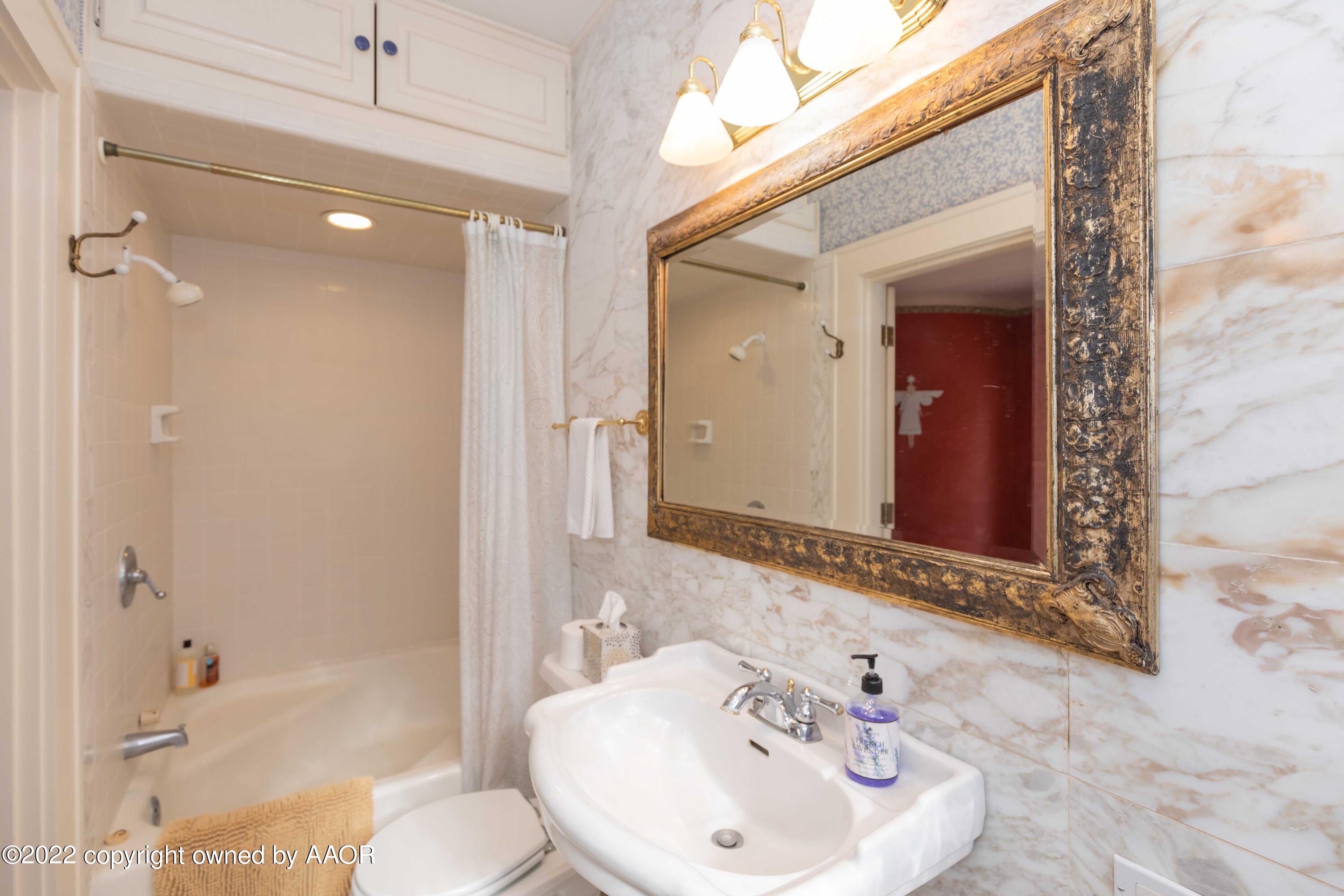 1607 South Harrison Street Amarillo, TX 79102 - Photo 56 of 71 a bathroom with a sink and a mirror