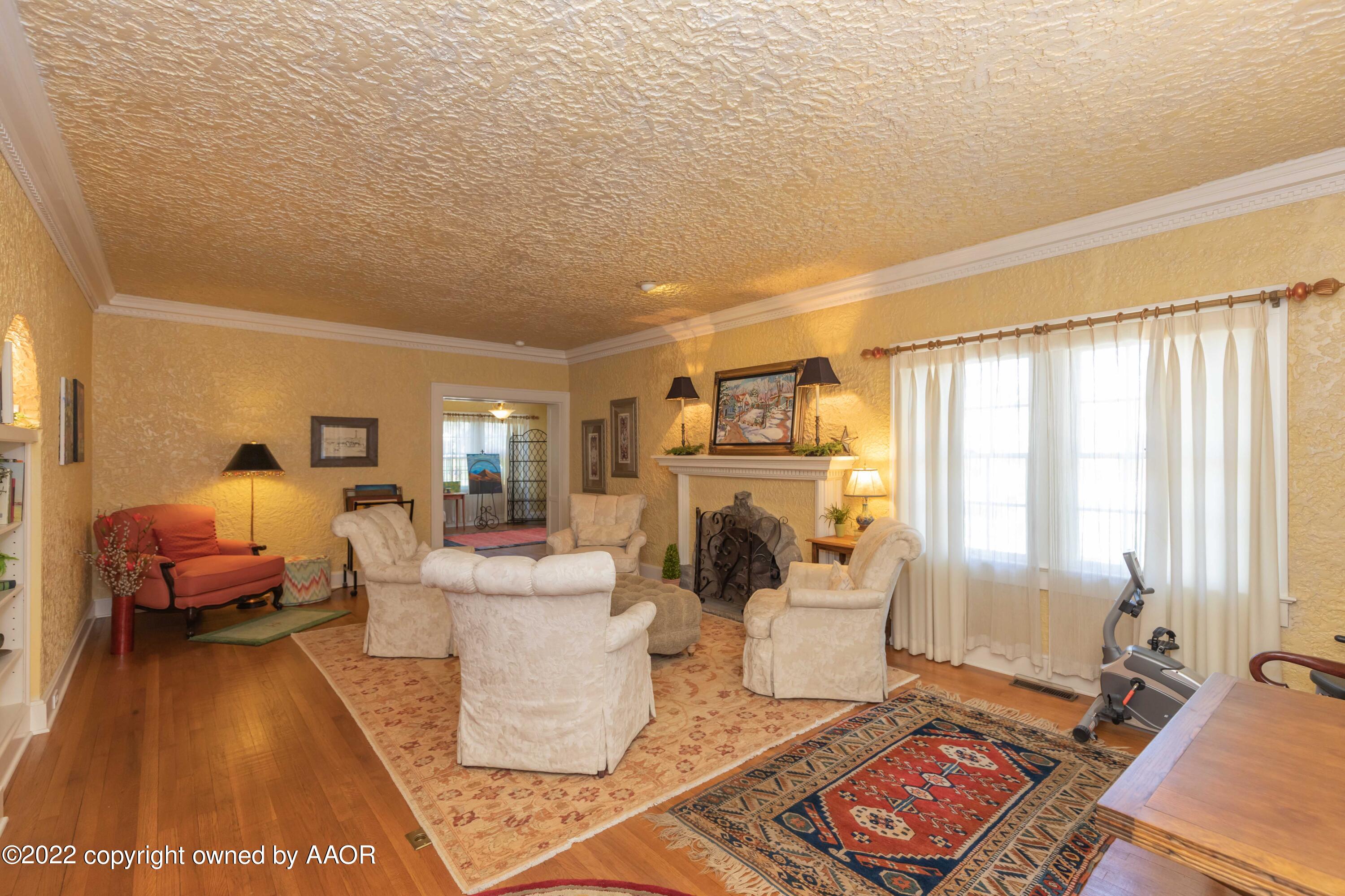 1607 South Harrison Street Amarillo, TX 79102 - Photo 8 of 71 a living room with furniture a large window and a fireplace