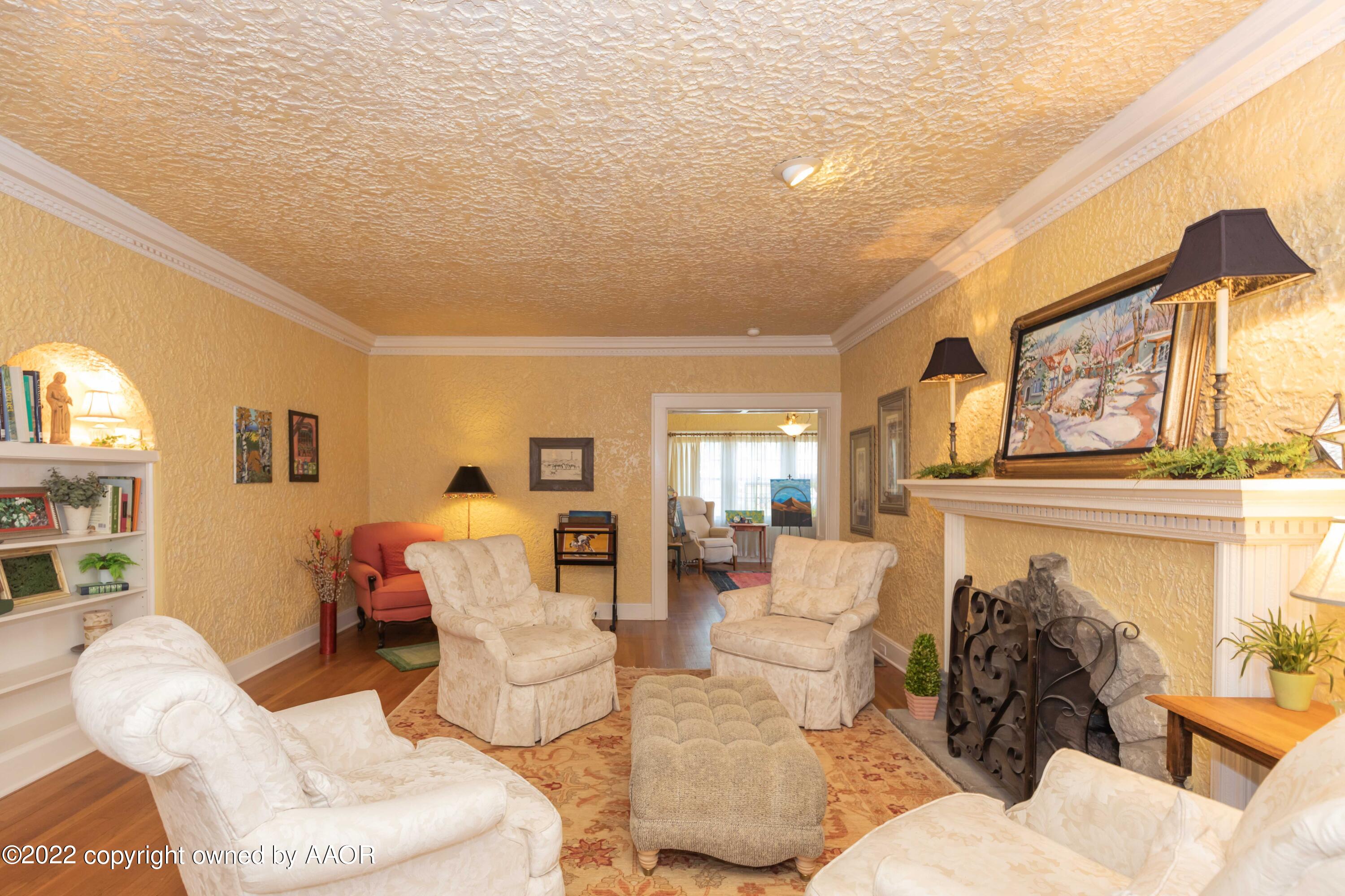 1607 South Harrison Street Amarillo, TX 79102 - Photo 9 of 71 a living room with furniture a fireplace and a large window