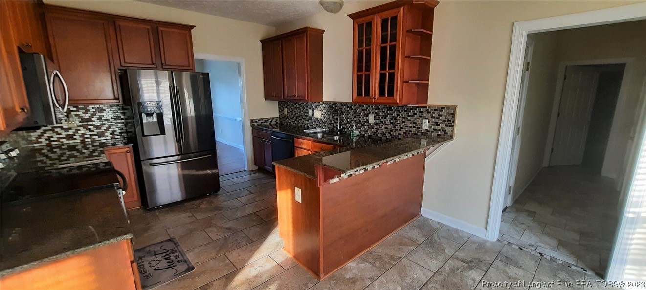 3513 Talus Road Fayetteville, NC 28306 - Photo 11 of 37 a kitchen with stainless steel appliances granite countertop a refrigerator and a stove