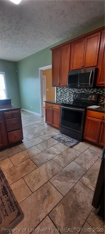3513 Talus Road Fayetteville, NC 28306 - Photo 16 of 37 a kitchen with stainless steel appliances kitchen island granite countertop a stove a sink and a microwave