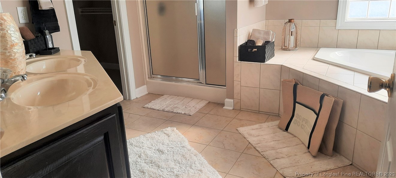 3513 Talus Road Fayetteville, NC 28306 - Photo 21 of 37 a bathroom with a sink and a mirror