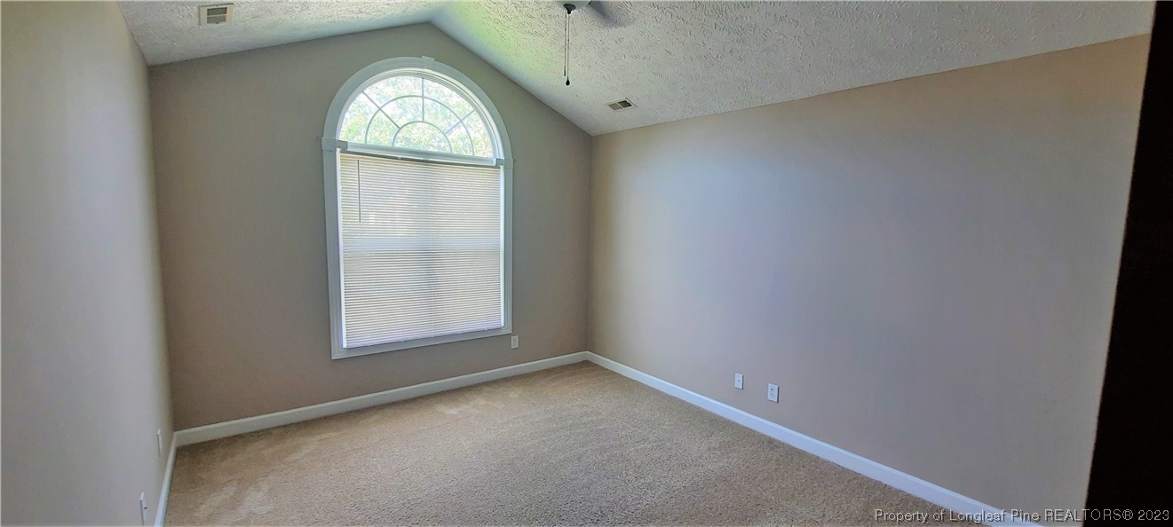 3513 Talus Road Fayetteville, NC 28306 - Photo 32 of 37 an empty room with window mirror and window