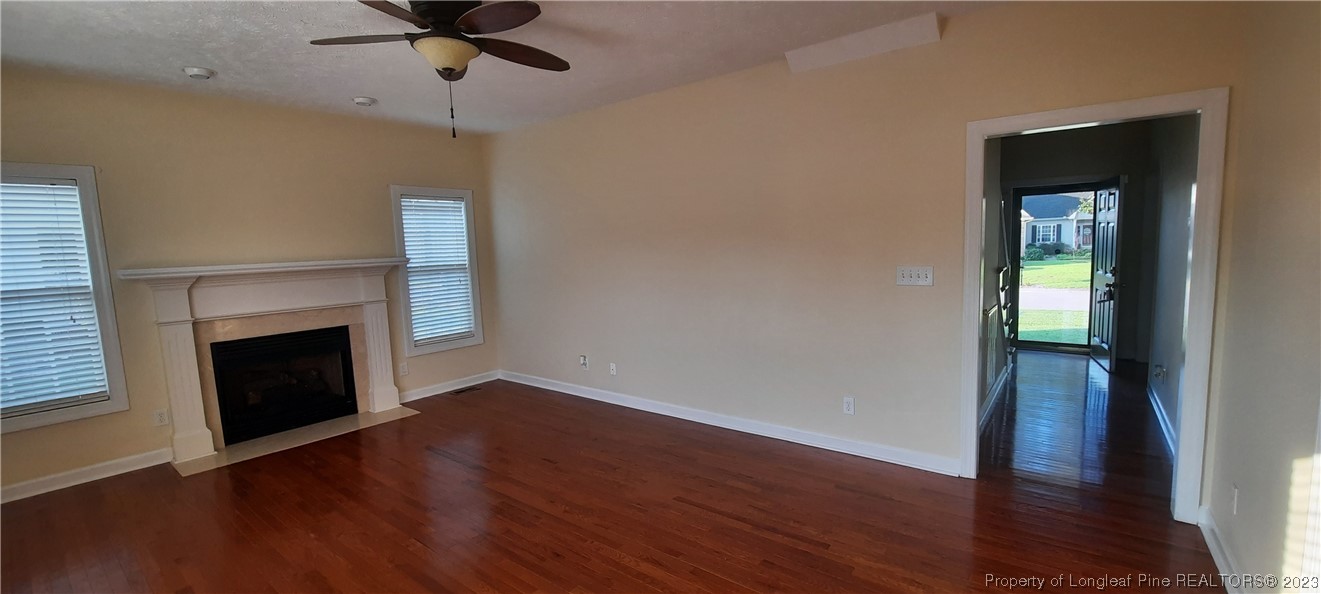 3513 Talus Road Fayetteville, NC 28306 - Photo 4 of 37 a view of an empty room with wooden floor and a fireplace