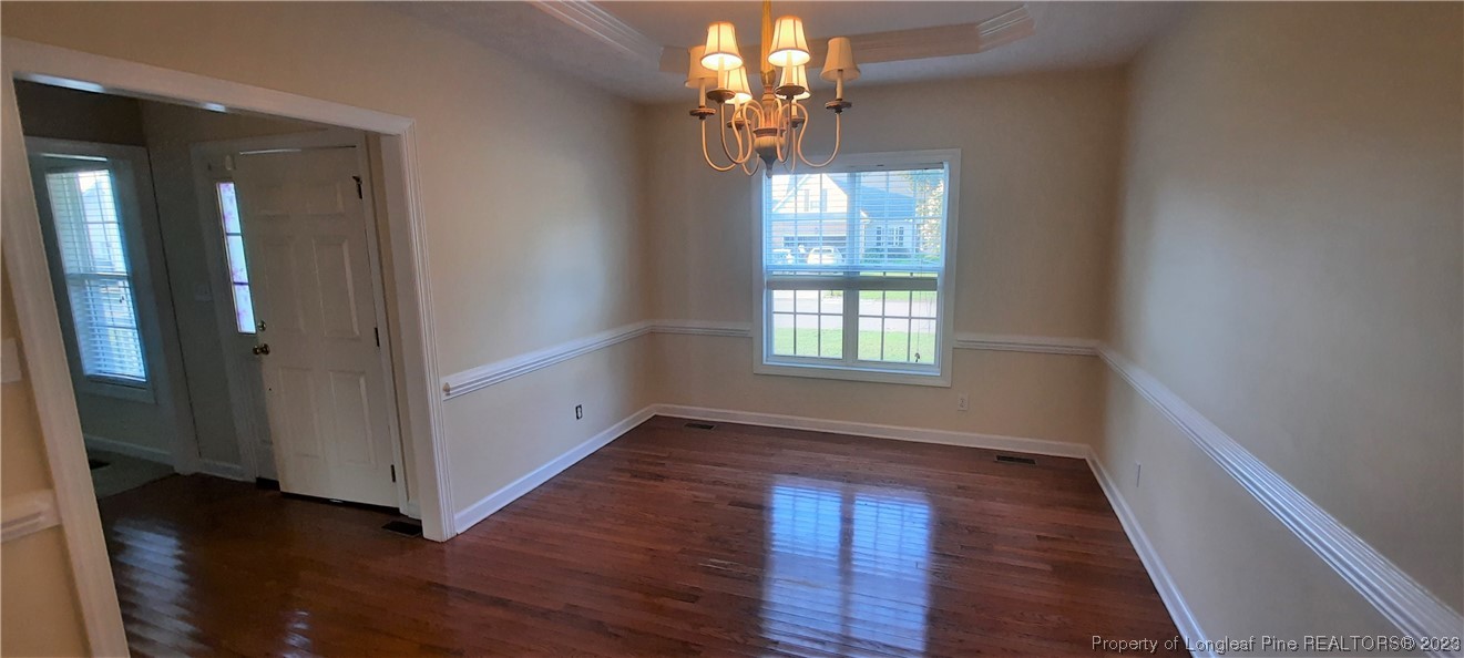 3513 Talus Road Fayetteville, NC 28306 - Photo 5 of 37 wooden floor in an empty room with a window