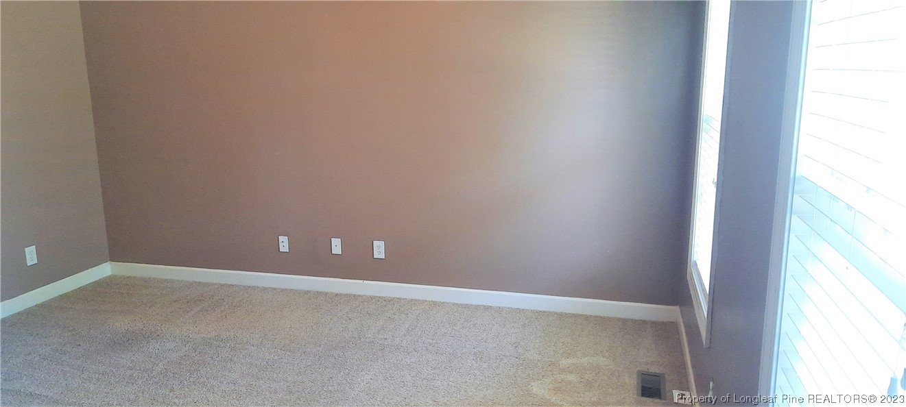 3513 Talus Road Fayetteville, NC 28306 - Photo 7 of 37 a view of an empty room and window
